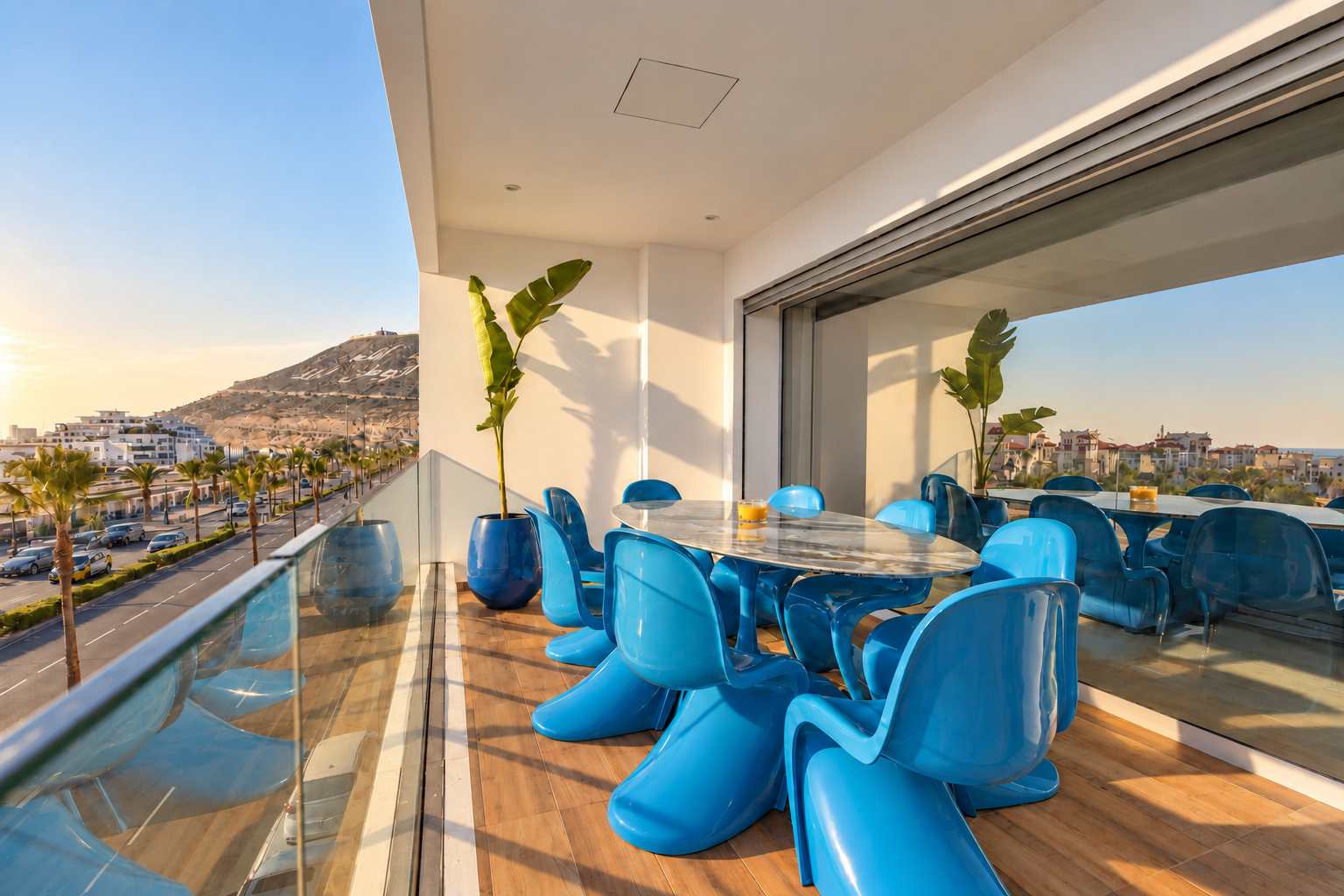 Terrasse avec table et chaises bleues face à l’océan, Agadir